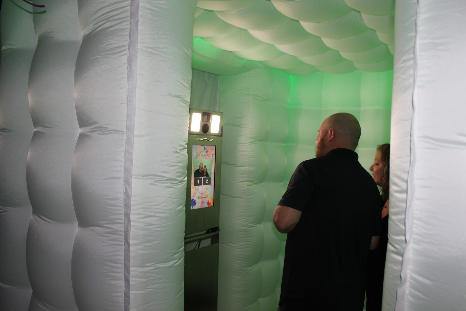Inside the LED cube photo booth with the touchscreen kiosk