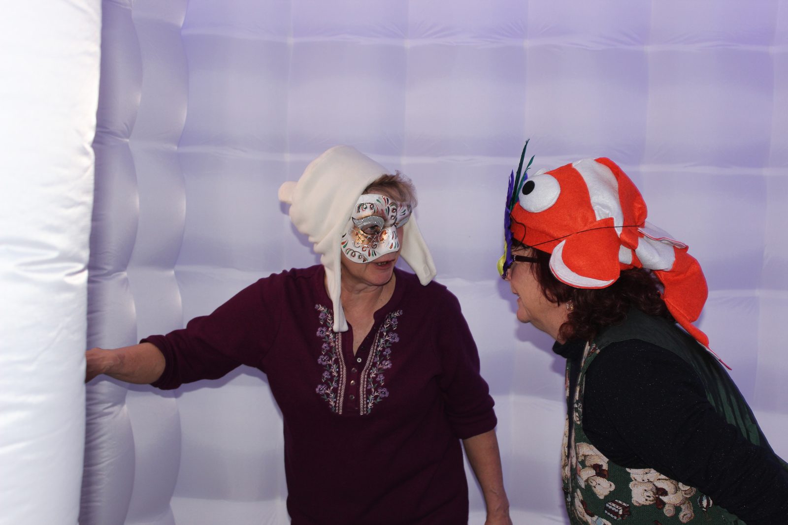 Guests in silly hats and masks inside the LED cube