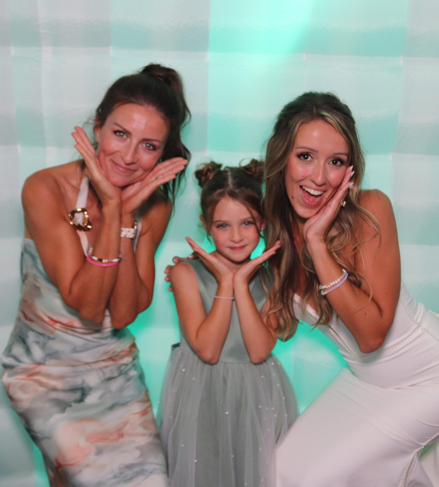 Bride and guests posing inside the LED cube