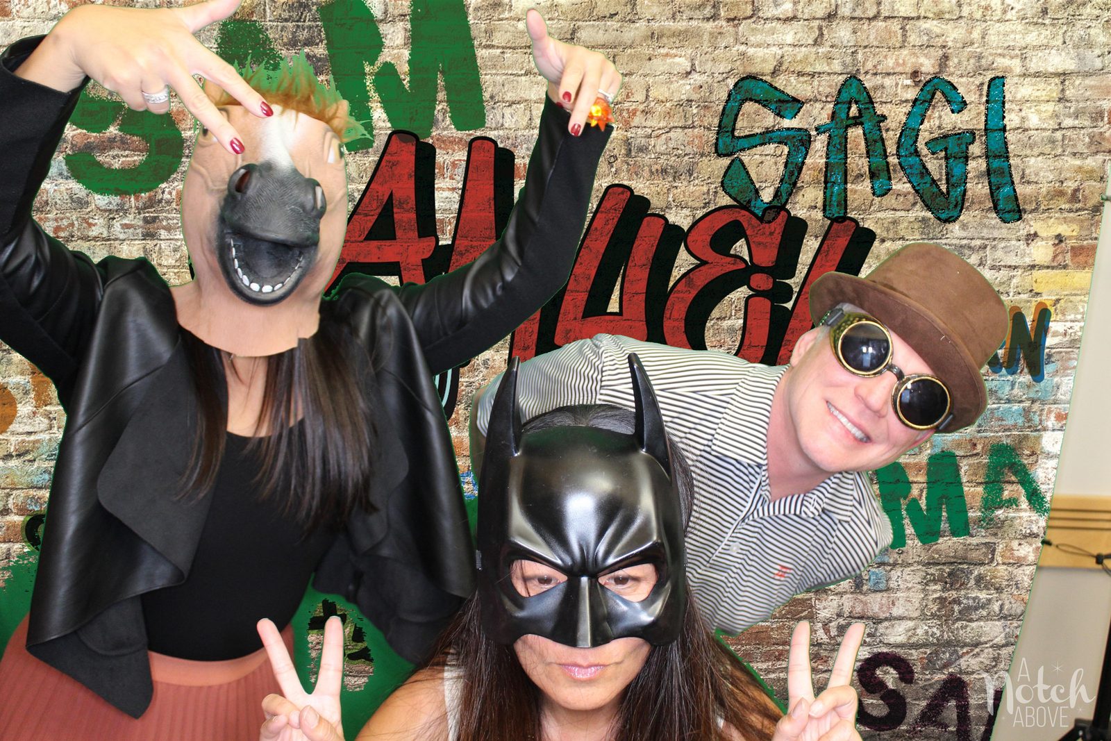 Guests in masks and props at a custom bar mitzvah backdrop